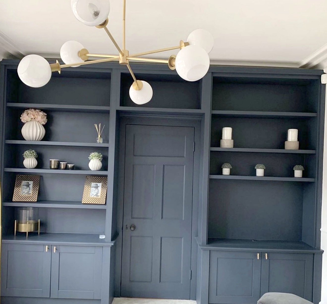 The finished bookcase wall, built around a panelled door
