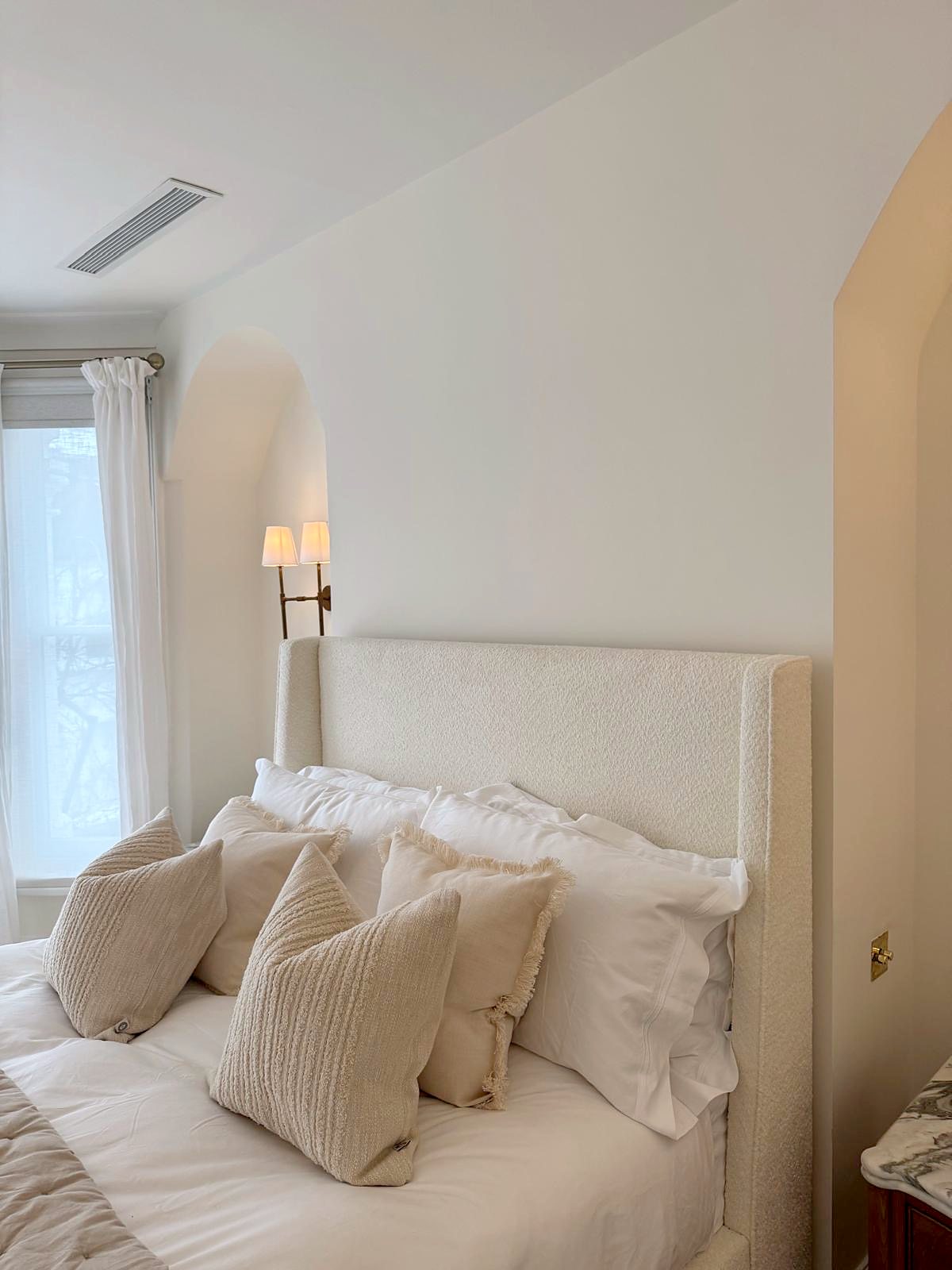 Bedroom with arched plaster niches finished by Krisel & Co