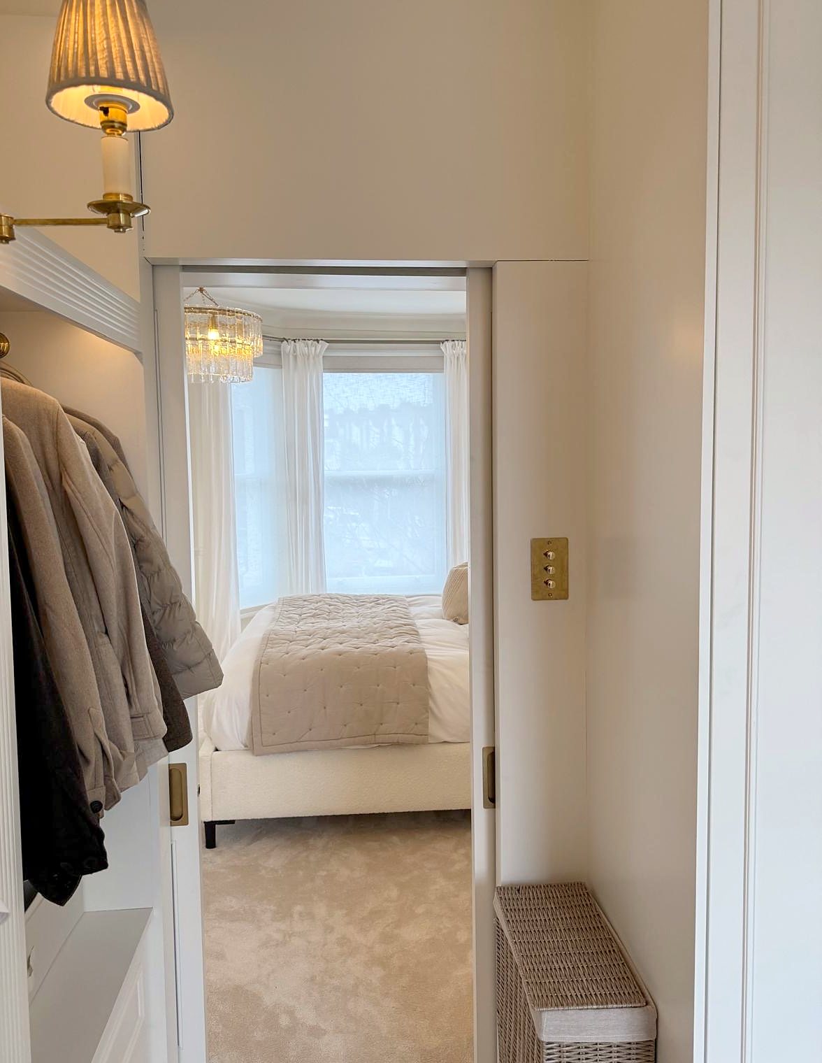 View from the dressing room through a pocket door to the bedroom
