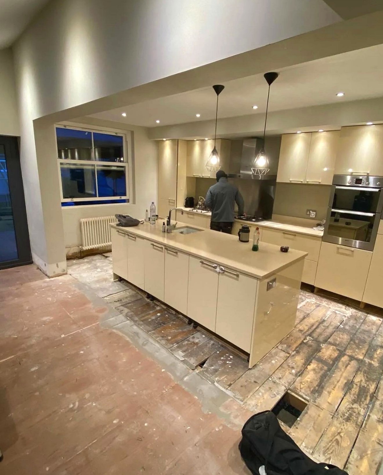 Before: cream gloss kitchen with the floor taken up